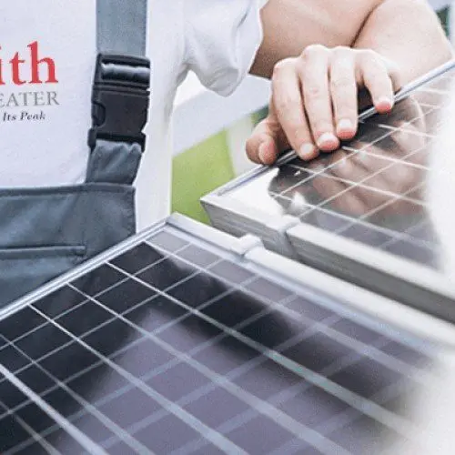 a hand touching solar panel